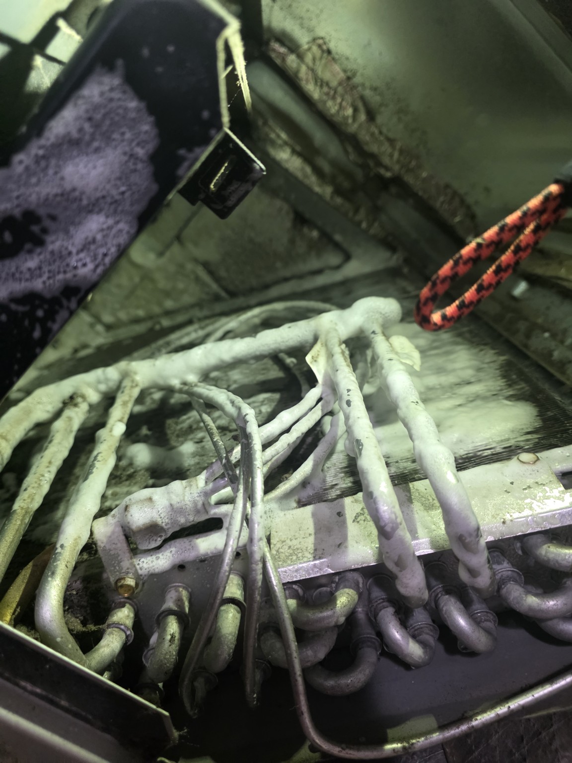 Evaporator coil being professionally cleaned during an Indianapolis AC tune-up